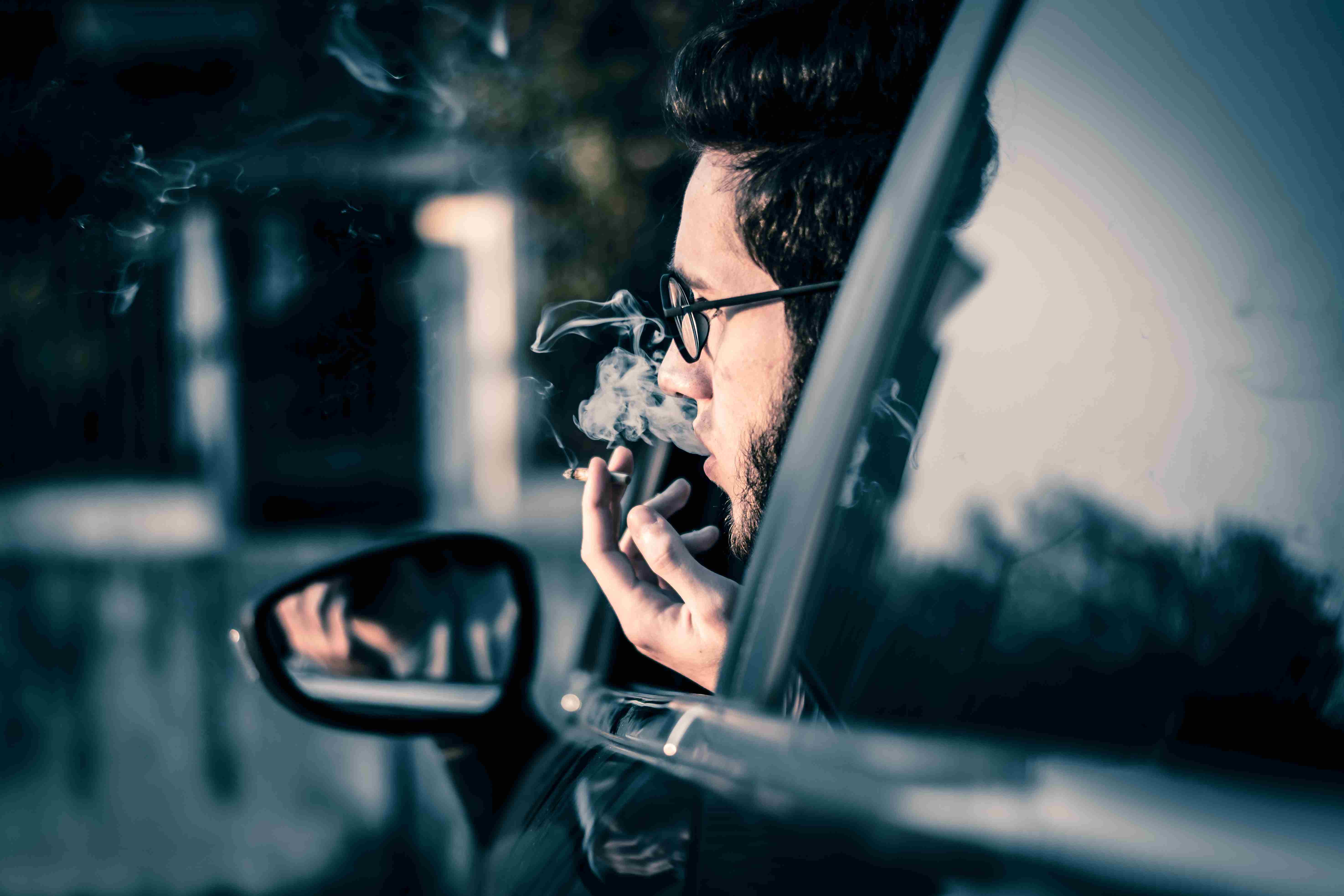 A man smoking while driving